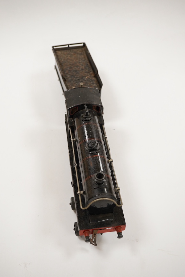 An 0 gauge Bing for Bassett-Lowke tinplate clockwork LNWR 4-4-0 tender locomotive, George the Fifth 2663, in red lined black livery with original clockwork mechanism